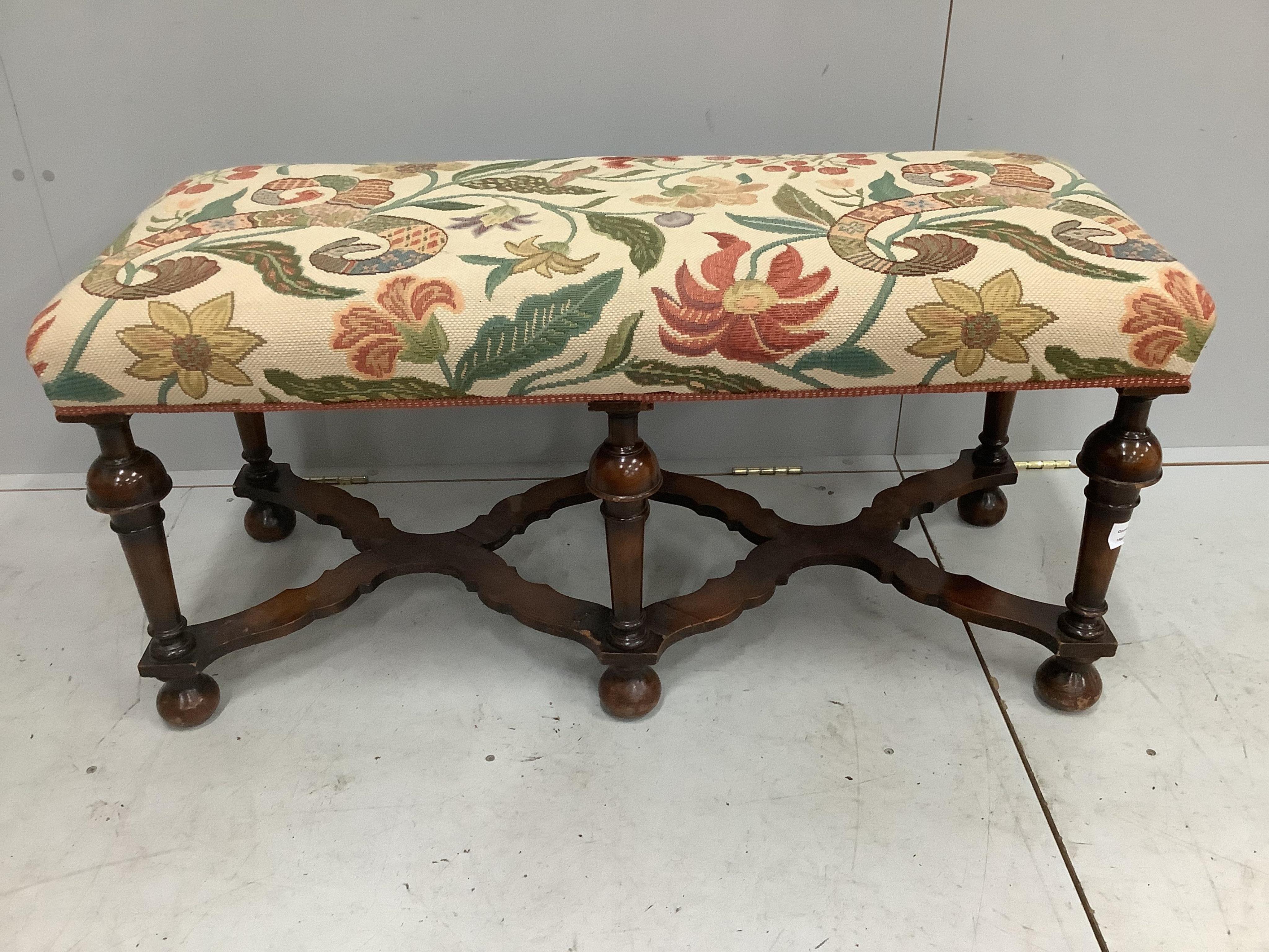 An early 20th century Jacobean Revival walnut dressing stool, width 109cm, depth 46cm, height 51cm. Condition - fair